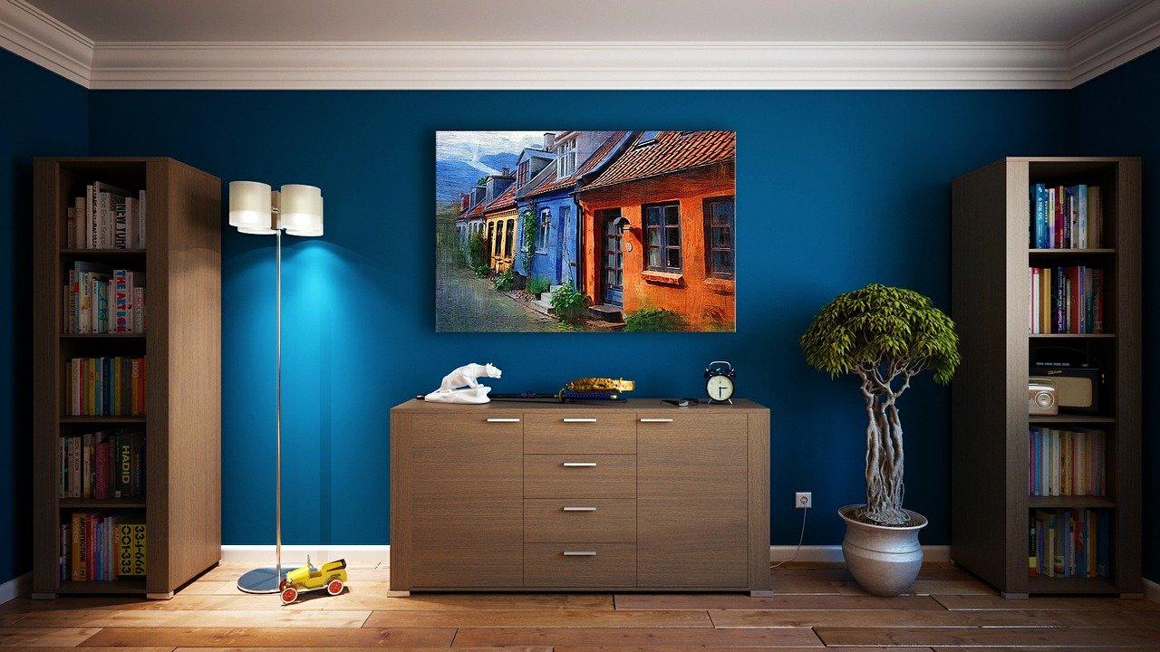 Interior of a room, blue walls, brown desk and lamp. MyHaus Brighton Estate Agency
